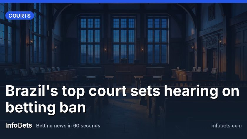 An empty courtroom chamber with tall windows & rows of vacant seats at dusk.