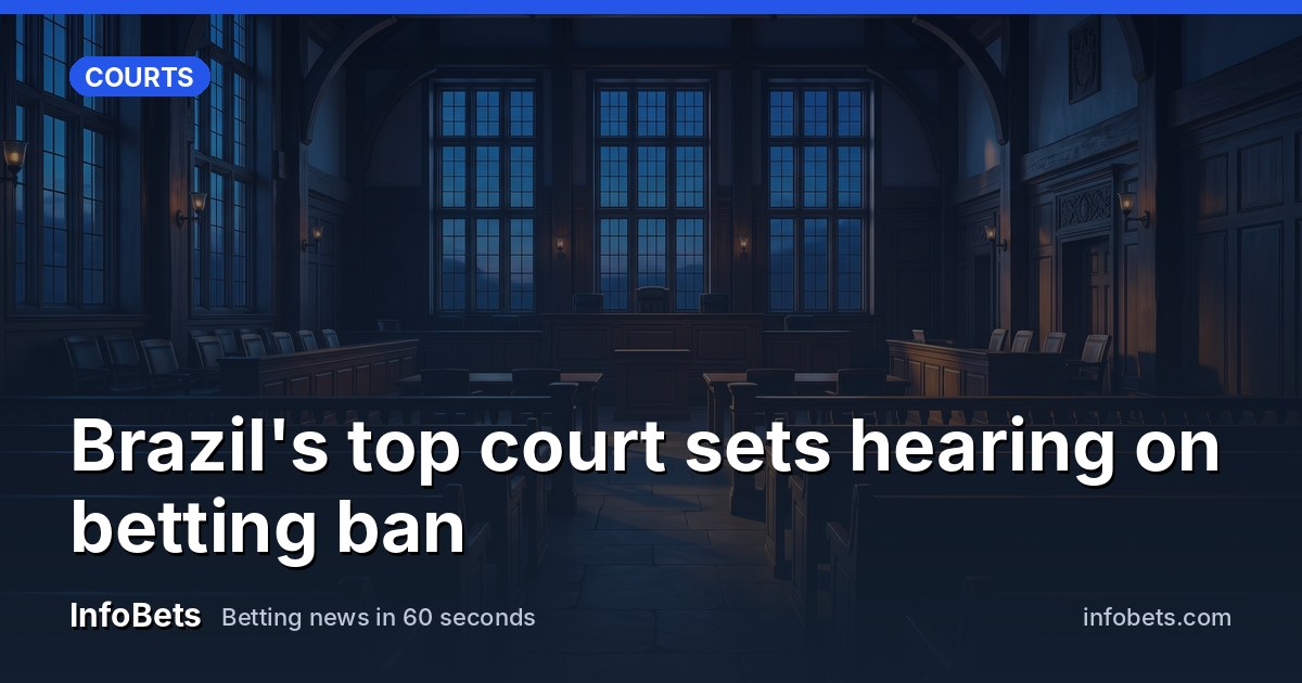 An empty courtroom chamber with tall windows & rows of vacant seats at dusk.
