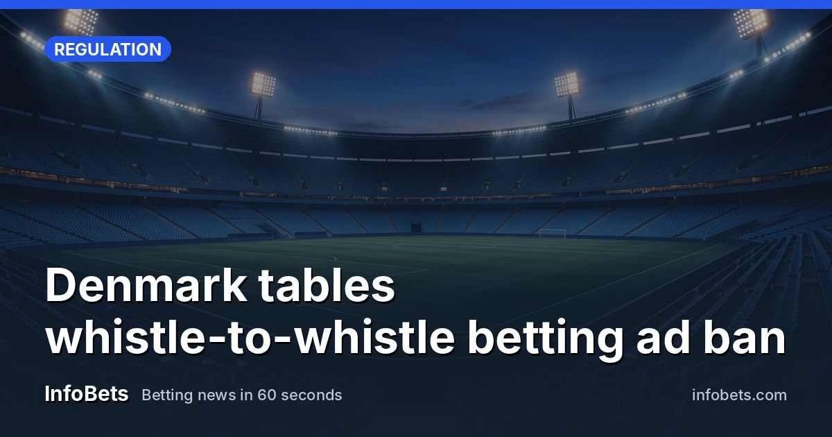 An empty outdoor sports stadium at dusk with floodlights on & no advertising boards visible.