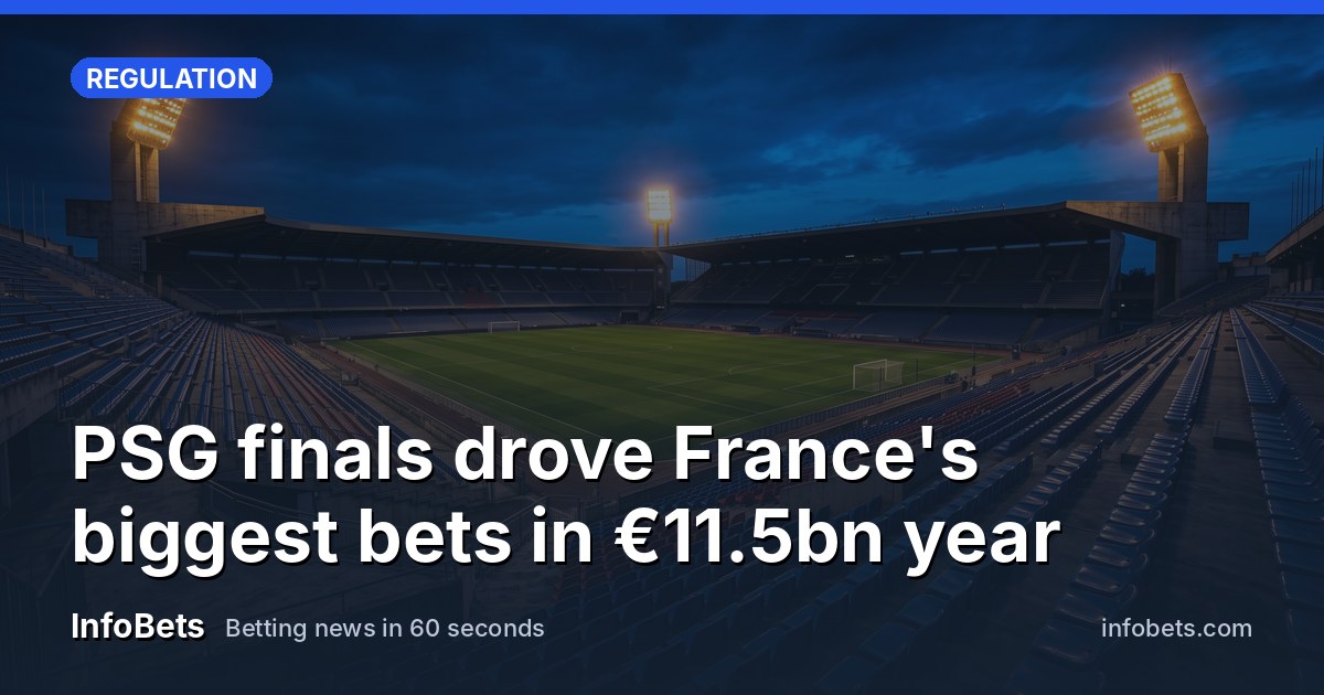 An empty French stadium at dusk with floodlights on & rows of vacant seats.