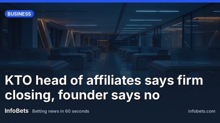 An empty corporate office floor at dusk with rows of vacant desks & no screens or paperwork visible.