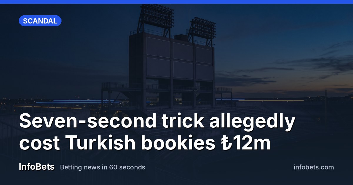 A tall, unlit stadium tower stands against a dusk sky, its blank rectangular panels dark and smooth, with floodlight rigs silhouetted above and empty tiered seats stretching quietly beneath in soft…
